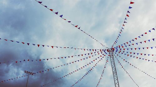 Low angle view of flags hanging against sky