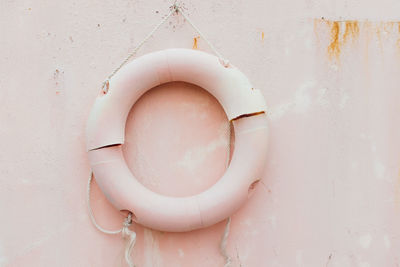 Close-up of life belt hanging on old wall