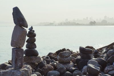 Rocks by sea against sky