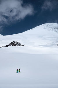 A team of two climbers with equipment goes up to the ascent