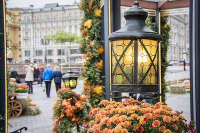 Autumn outdoor decorations at local farm market. people at the street of a city.retro lantern