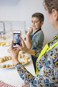 Mother and son making croquettes in the kitchen