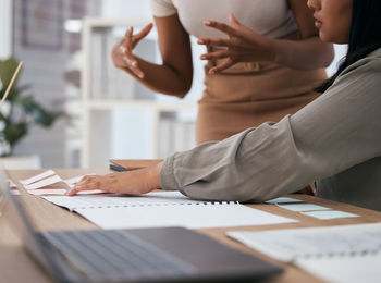 Midsection of business colleagues working at office