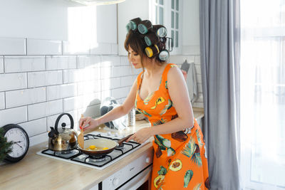 Portrait of young woman using mobile phone at home