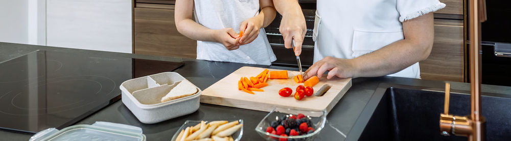 Midsection of man preparing food in kitchen at home