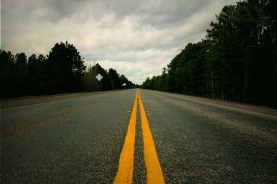 Surface level of empty road against sky