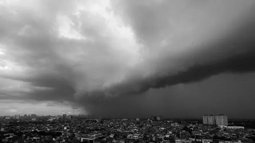 Cityscape against cloudy sky