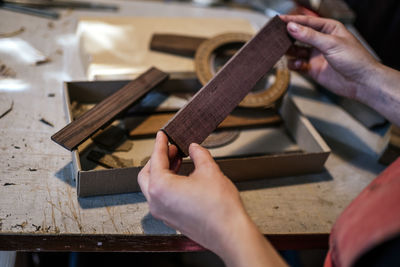 Unrecognized luthier woman in traditional workshop