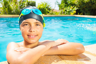 Portrait of young woman swimming in pool