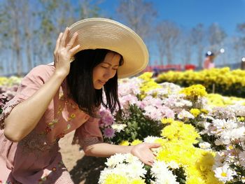 Full length of woman with pink flowers