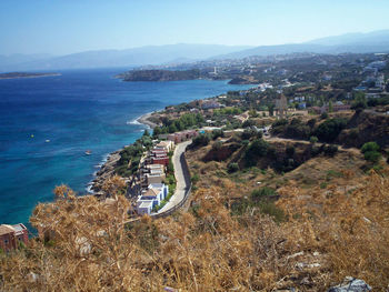 High angle view of townscape by sea against sky