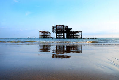 Lifeguard hut on beach against sky