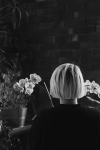 Rear view of woman with flowers in hair