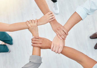 Cropped image of couple holding hands