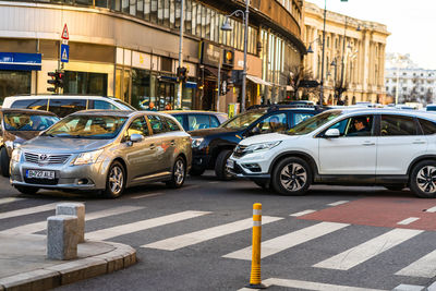 Vehicles on road along buildings