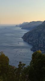 Scenic view of sea and mountains against sky