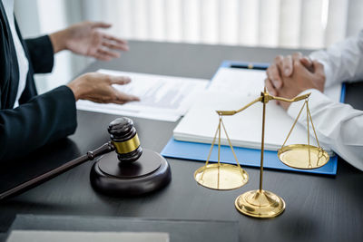 Midsection of lawyer working at table