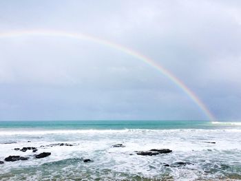 View of rainbow over sea against sky