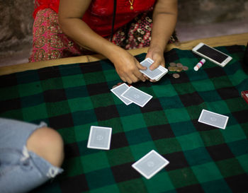 High angle view of woman playing with text on table