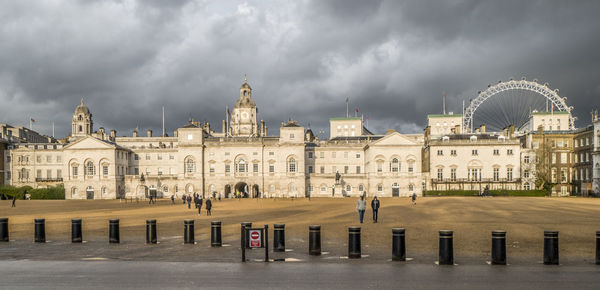 Buildings in city against cloudy sky in london