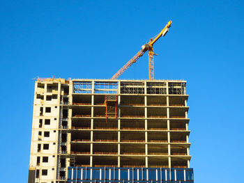 Low angle view of building against clear blue sky