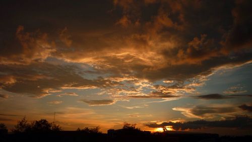 Silhouette of landscape against cloudy sky