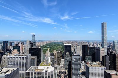 Central park amidst cityscape against sky