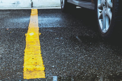 High angle view of yellow arrow symbol on road