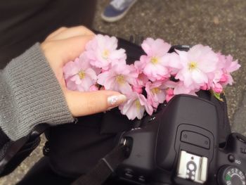 Woman holding pink flowers