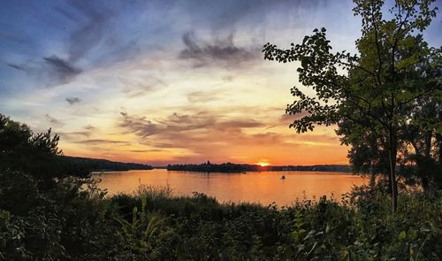 Scenic view of lake against sky during sunset