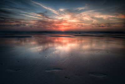 Scenic view of calm sea at sunset