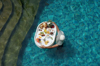 High angle view of person floating on swimming pool