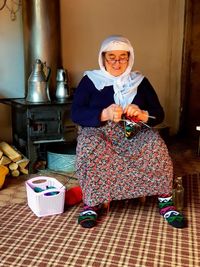 Woman knitting wool at home