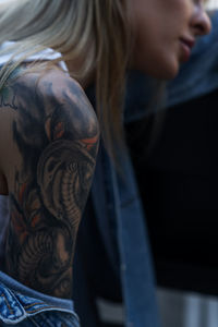 Tattooed shoulder girl close-up