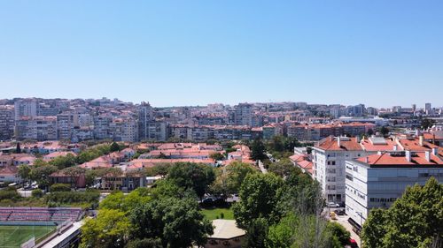 High angle view of townscape against blue sky