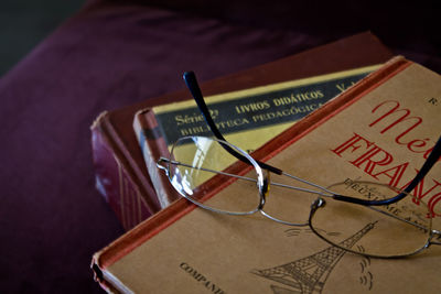 Books with glasses on table