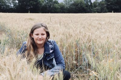 Portrait of smiling young woman in field