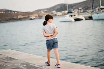 Full length of girl walking on pier