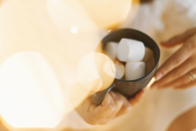 Midsection of woman holding coffee