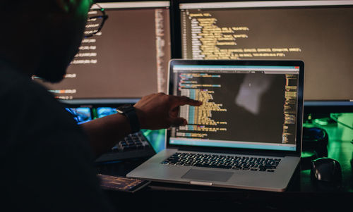 African american or black man at computer desk programming apps or web developing