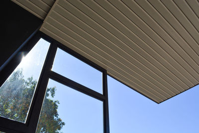 Low angle view of building seen through glass window