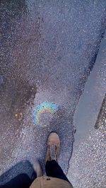 Low section of woman standing on puddle