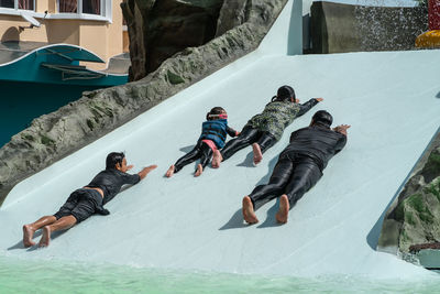 High angle view of people skiing on snow covered field