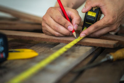 Cropped hands of person working on table