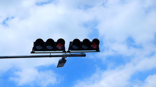 Low angle view of traffic signal against sky