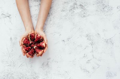 Directly above shot of hand holding strawberry