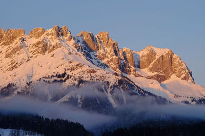 Scenic view of snowcapped mountains against clear sky