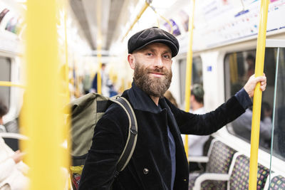 Smiling mature man traveling in train