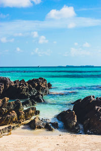 Scenic back rocks and turquoise sea against the sky on the beach of tanjung gelam