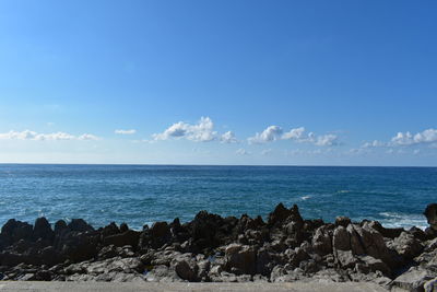 Scenic view of sea against blue sky